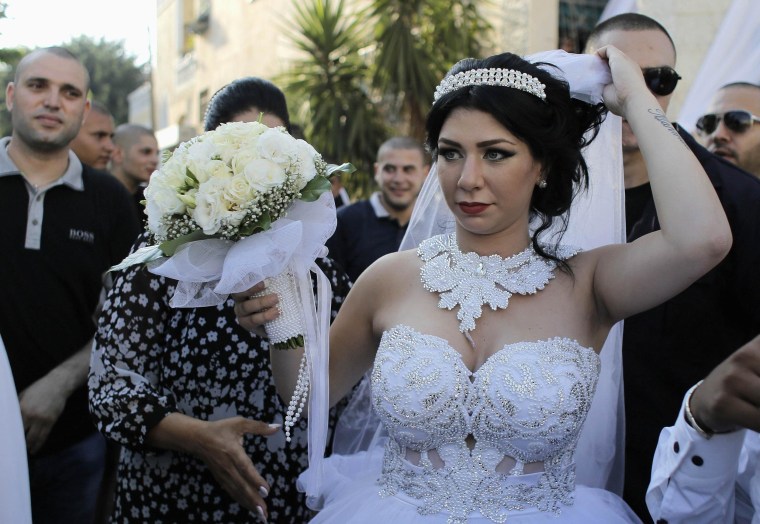 Image: Bride Maral Malka, 23, celebrates with friends and family before her wedding to groom Mahmoud Mansour, 26, in Jaffa, south of Tel Aviv