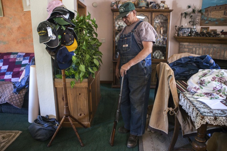 IMAGE: Nucla Town Board member Les Mahana shows one of his guns at his home in Nucla