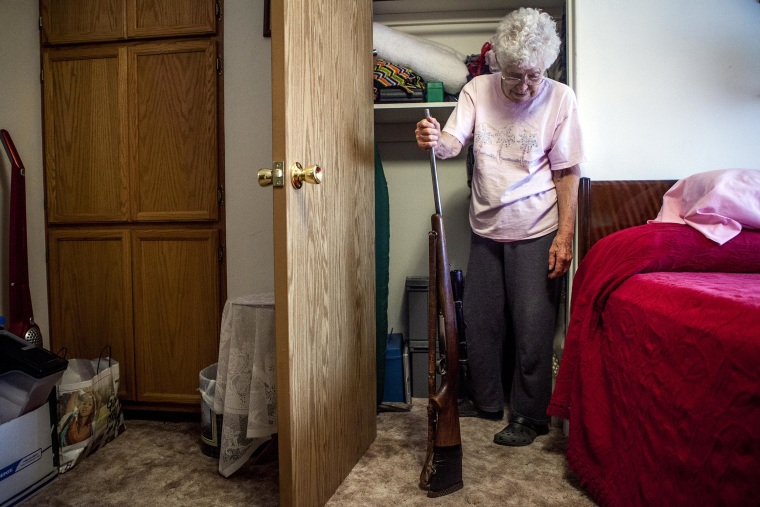 IMAGE: At her home in Nucla, Colo., historian Marie Templeton retrieves the gun her husband gave her for their second anniversary more than 60 years ago. 