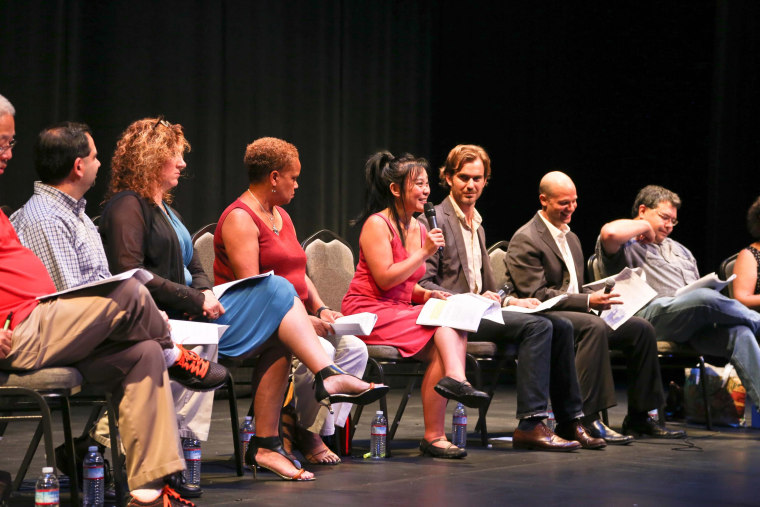 Image: A diverse panel of theater directors and arts administrators at Seattle Repertory Theatre take part in a  community forum