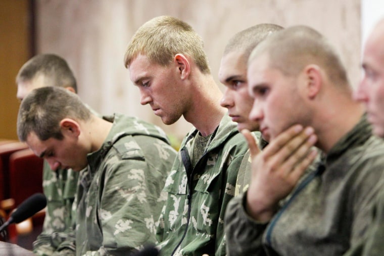 Image: A group of Russian servicemen, who are detained by Ukrainian authorities, attend a news conference in Kiev
