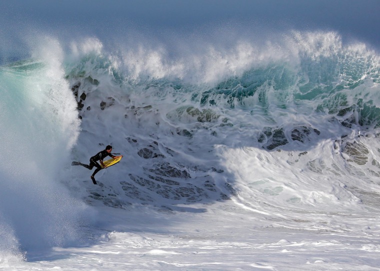 Image: A bogieboarder rides a wave at 'The Wedge' in Newport Beach, Calif.