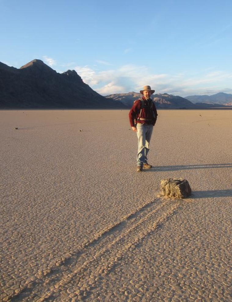 Image: Biologist Richard Norris stands next to a Racetrack Playa rock trail