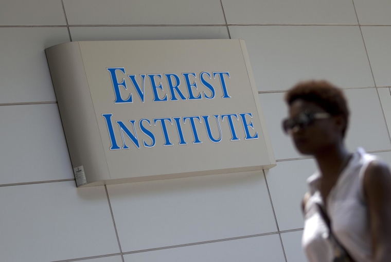 Image: A person walks past an Everest Institute sign in a office building in Silver Spring, Md., on July 8.