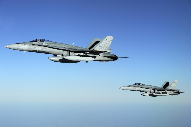 Two CF-18 fighter jets from the 425 Tactical Fighter Squadron in Bagotville fly over the Mediterranean Sea near Trapani, Sicily, in this Canadian Forces handout photo dated April 3, 2011. Canada has deployed six CF-18 (CF-188) Hornets to enforce the no-fly zone over Libya. 