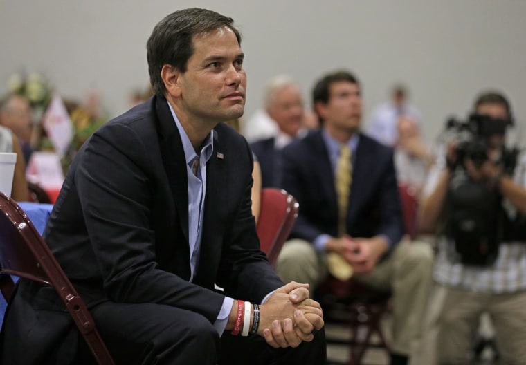 Sen. Marco Rubio, R-Fla., listens to a speaker during the fourth annual "Faith and Freedom BBQ" hosted by U.S. Rep. Jeff Duncan in Anderson, S.C., Monday, Aug. 25, 2014. (AP Photo/Chuck Burton)