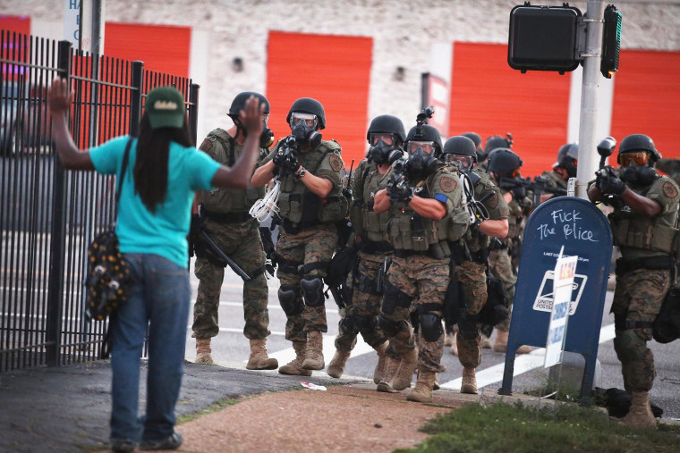 Image: Police force protestrs from the business district into nearby neighborhoods on August 11, 2014 in Ferguson, Missouri