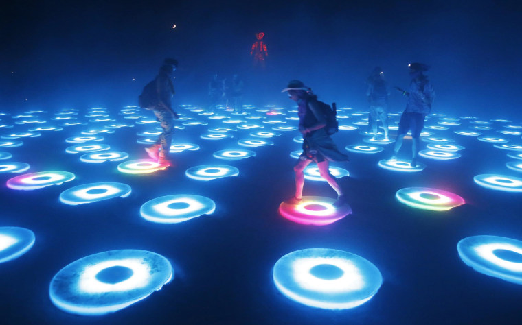 Image: Participants interact with the art installation The Super Pool during a dust storm at the Burning Man 2014 "Caravansary" arts and music festival in the Black Rock Desert of Nevada