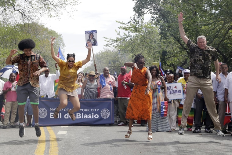 New York Mayor Bill de Blasio, his children, Dante and Chiara, and wife, Chirlane McCray, do the "Smackdown" dance move as they march in the West Indian Day Parade, on Sept. 1, in Brooklyn, N.Y.