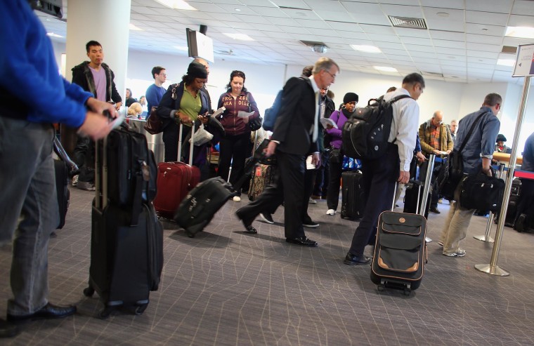 Image: Passengers wait to board their plane at the Delta terminal in LaGuardia Airport 