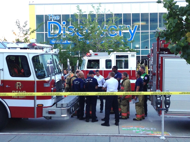 Image: Firefighters confer out side the Nevada Discovery Museum in Reno, Nev.