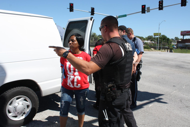 Image: Police in Kansas City handcuffed Latoya Caldwell, 31, and led her into a police van after she was arrested with dozens of other fast food workers who participated in civil disobedience. Caldwell arranged for a friend to pick up her four children fr