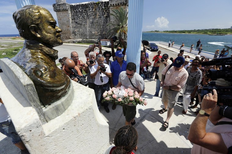 Image: The grandsons of Ernest Hemingway, John and Patrick, and others lay a wreath at the bust of the acclaimed writer