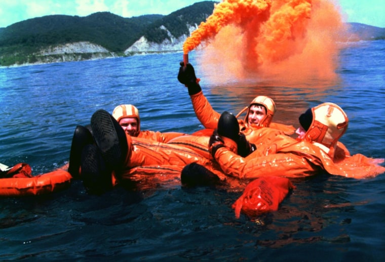 Members of the first International Space Station crew, including Russian cosmonauts Yuri Gidzenko and Sergei Krikalev plus NASA astronaut Bill Shepherd, practice water survival skills in the Black Sea in 1997.