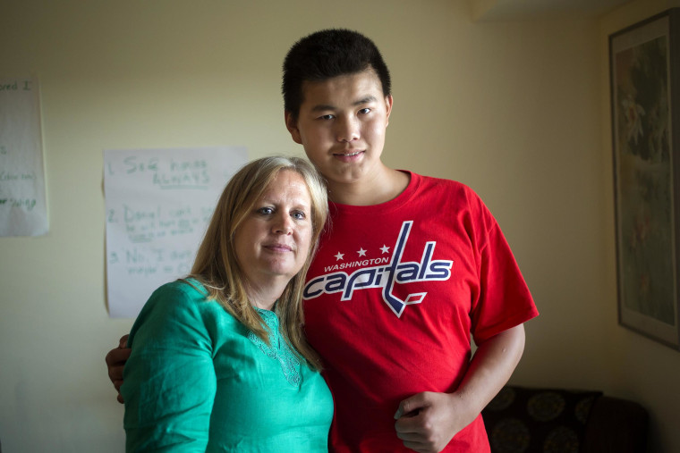 Image: Christine Ogden converses using sign language with her adopted son Daniel