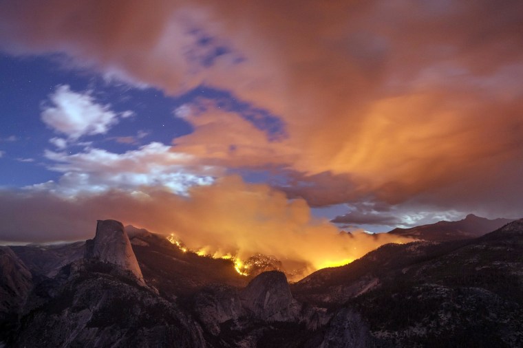 Image: A wildfire burns next to Half Dome in Yosemite National Park
