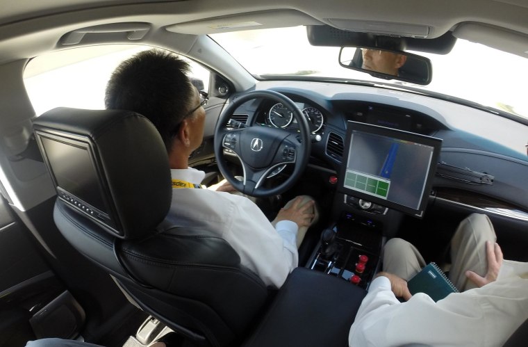 Image: The driver of a prototype Acura RLX sedan places his hands on his knees during a driving demonstration in Detroit, Tuesday, Sept. 9, 2014.