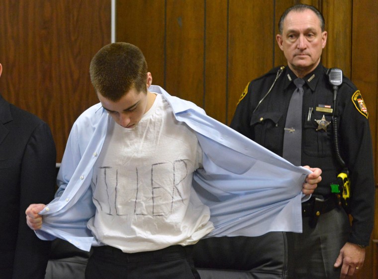 Image: Lane shows his t-shirt with the words "Killer" at his sentencing in Cleveland