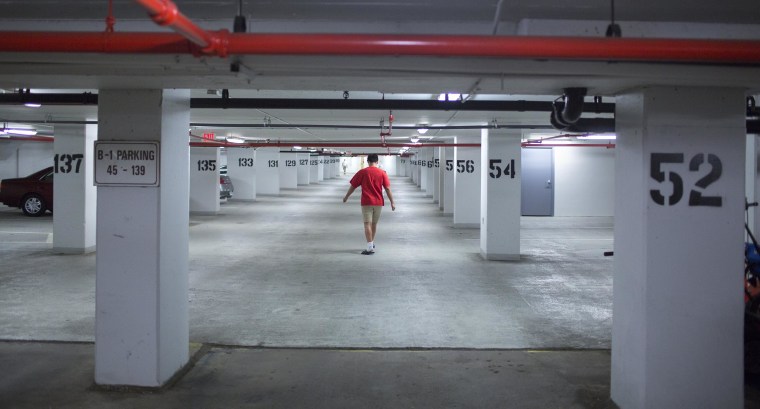 Image: Daniel Ogden, 14, walks through the parking garage in the apartment building where he lives with his adoptive family in Alexandria. Va. Christine and her husband Scott have seven children, four of whom they adopted. 