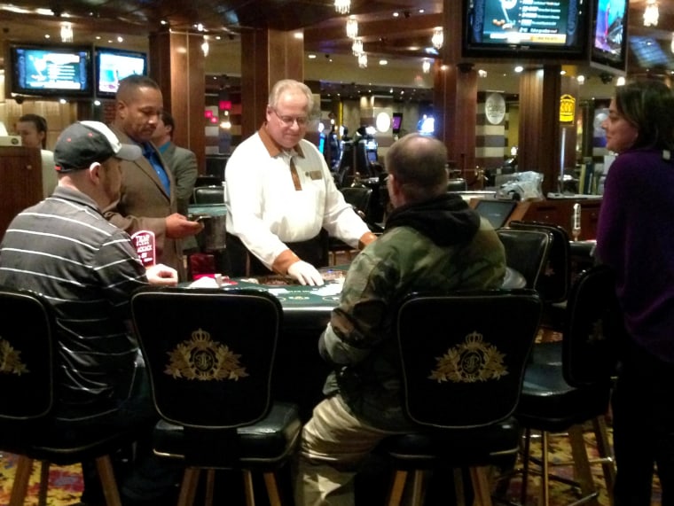 A dealer deals the final hand of blackjack at Trump Plaza Hotel and Casino in Atlantic City, N.J., seconds before the casino closed on Tuesday, Sept. 16. Trump Plaza is the fourth Atlantic City casino to go out of business so far this year.