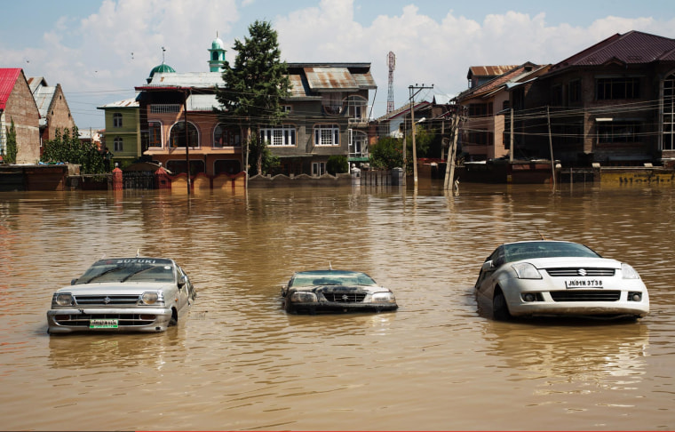 Image: Cars sit submerged on a road in the flooded Bemina area in Srinagar