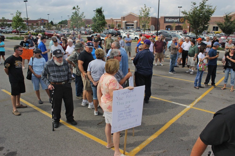 Image: People gather in a parking lot to support the Beavercreek Police Department in Beavercreek, Ohio