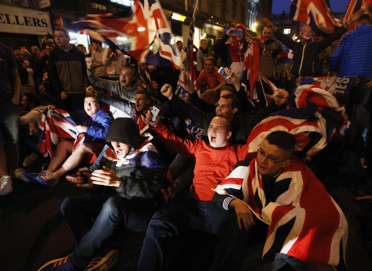 Image: Pro-union protestors chant and wave Union Flags during a demonstration at George Square in Glasgow