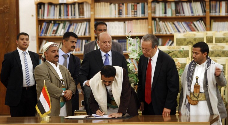 Image: Mehdi Al-Mashat, representative of Houthi leader Abdul-Malik al-Houthi, signs an agreement in Sanaa