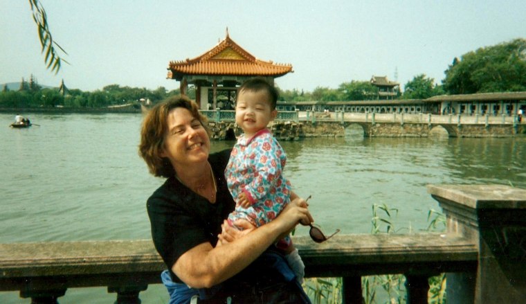 Image: Kate Crotty poses with mom in Wuxi, China during adoption process in 1997.