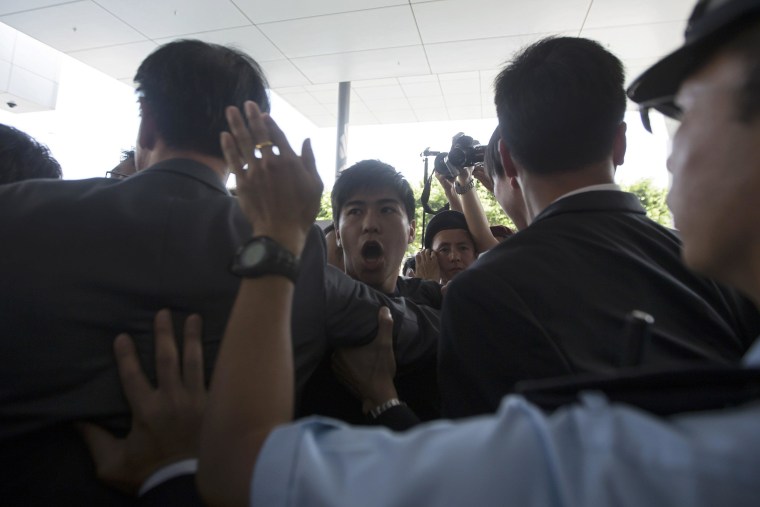 Image: Police stop student protesters as they rush to meet Chief Executive Leung Chun-ying at government headquarters in Hong Kong