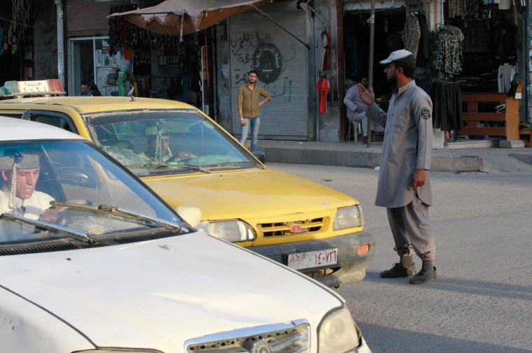 Image: An ISIS police officer directs traffic in Raqqa, Syria, on Sept. 18