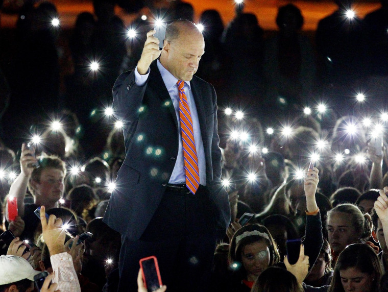 Image: Clemson University President Jim Clements leads a moment of silence during a vigil for Tucker Hipps on Tuesday at Bowman Field.