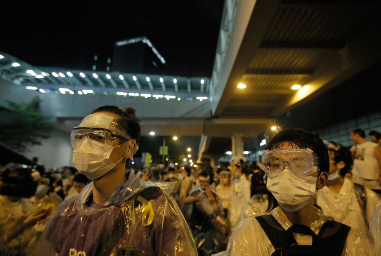 Image: Protesters wearing masks and goggles gather outside the government headquarters in Hong Kong
