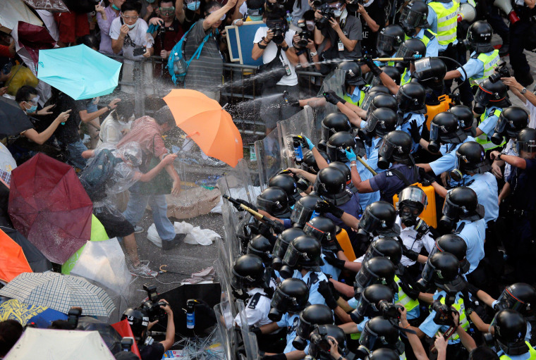 Image: Riot police use pepper spray against protesters