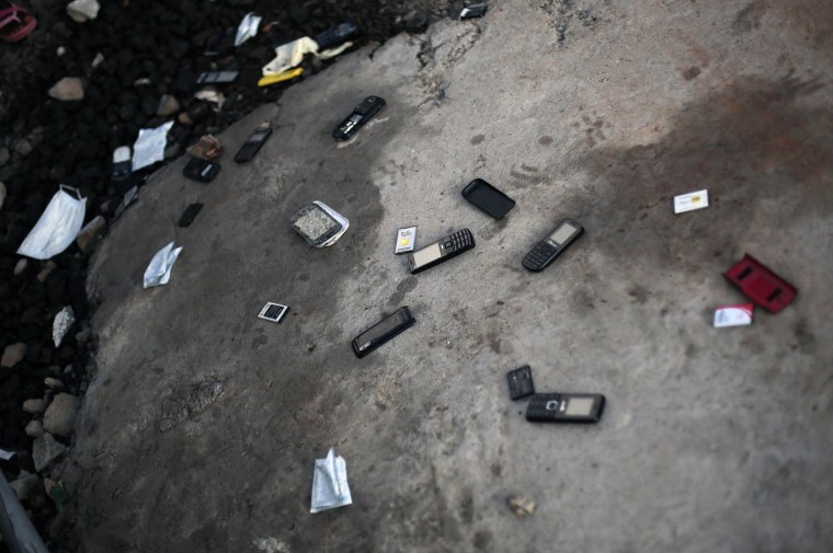 Image:Cellphones are thrown on the ground by patients leaving  the Island Clinic Ebola treatment unit
