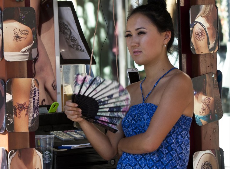 Image: Henna tattoos saleswoman Zhibek Nurmanbetova fans herself in Hollywood on Thursday