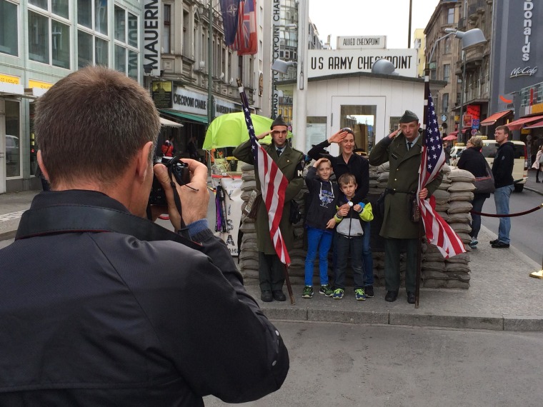 Image: Tourists at the former Checkpoint Charlie border crossing in Berlin