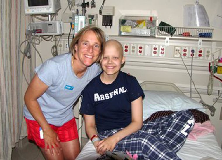 Annika Dybevik, 18, in her hospital bed being visited by coach Amy Griffin. 
