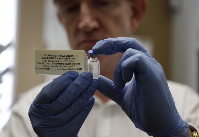 Image: Professor Adrian Hill, director of the Jenner Institute and chief investigator of the trials with the Ebola vaccine Chimp Adenovirus type 3 (ChAd3), holds a vial of the vaccine before injecting it into British volunteer Ruth Atkins