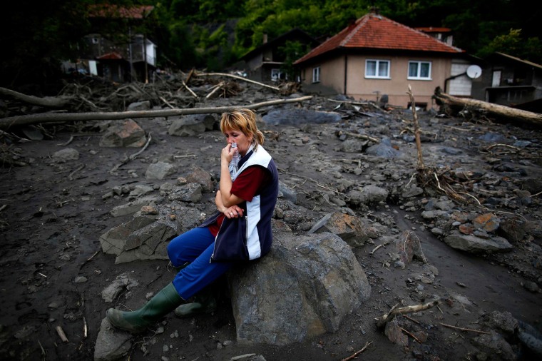 Image: Fata Kovacevic reacts near her flood-damaged house in Topcic Polje