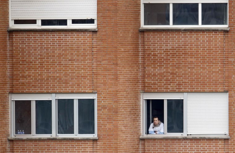 Image: Javier Limon Romero, the husband of Spanish nurse Teresa Romero Ramos who contracted Ebola, looks out of the window of a ward he is being kept isolated in, at Madrid's Carlos III hospital