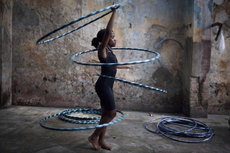 Image: Girl performs with hoops during a training session at a circus school in Havana