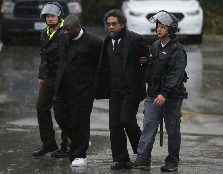 Image: Activist Cornel West is detained by police during a protest at the Ferguson Police Department in Ferguson