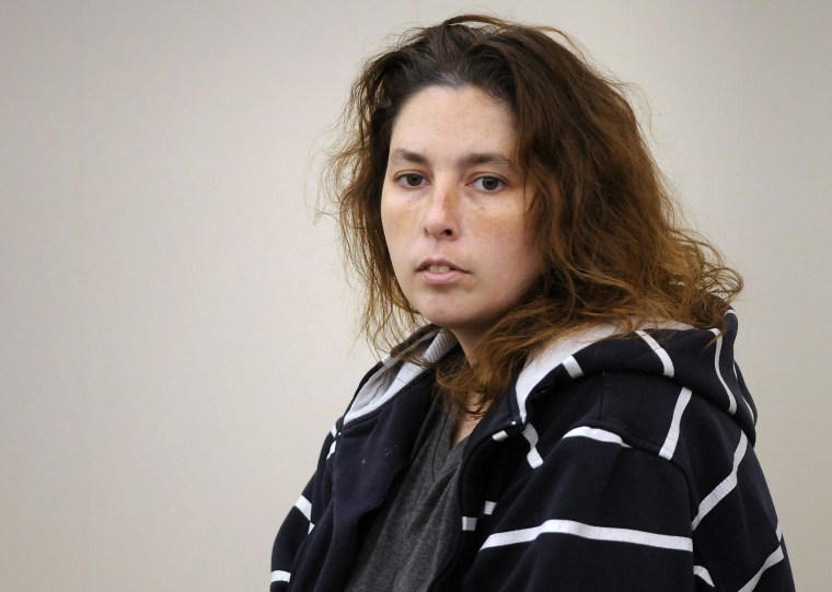 Image: Erika Murray, who was arrested after the bodies of three dead infants were found in her home in the town of Blackstone, sits in the district court for her arraignment in Uxbridge