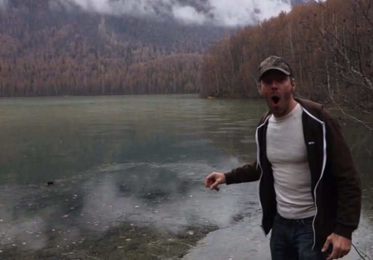 Image: Cory Williams reacts to the sound of a rock hitting a frozen lake
