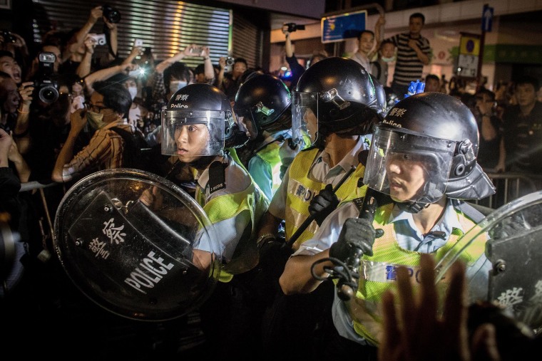 Image: Pro-democracy protesters push police back as they break down barricades and take back streets in Mong Kok on Oct. 18