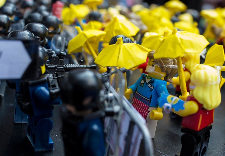 Image: Toy Lego characters depicting a scene of protesters confrontation riot police are seen on a table outside the government headquarters in Hong Kong
