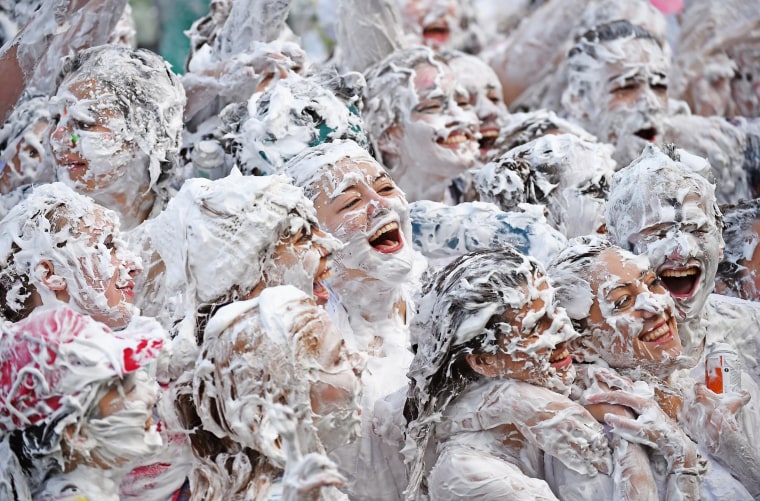 Image: First year students from St. Andrew's University cover themselves in foam