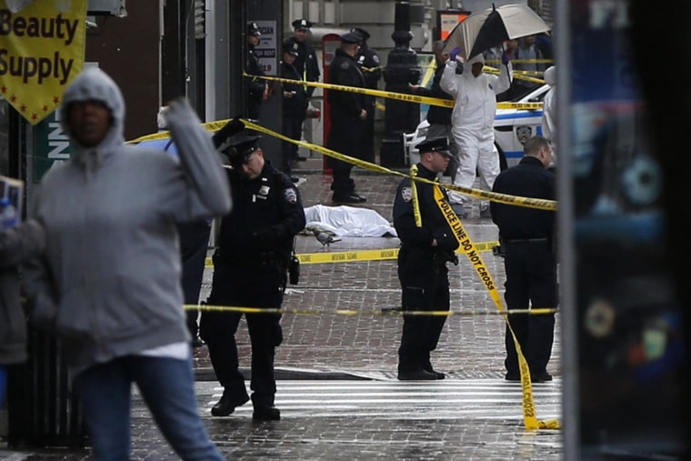 Image: A body lays covered on Jamaica Avenue near 162nd street in the borough of Queens in New York