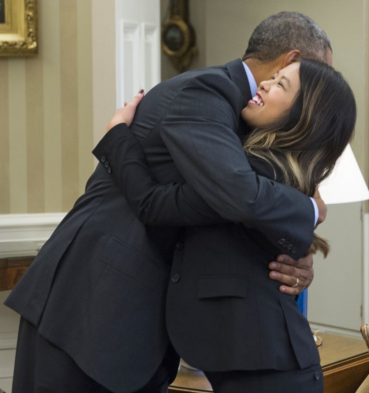 President Barack Obama hugs nurse Nina Pham, who was declared free of the Ebola virus after contracting the disease while caring for a Liberian patient in Texas, during a meeting in the Oval Office of the White House in Washington, DC, October 24, 2014. 